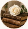 A white rose rests on top of two stacked vintage books, with a cup in the background.